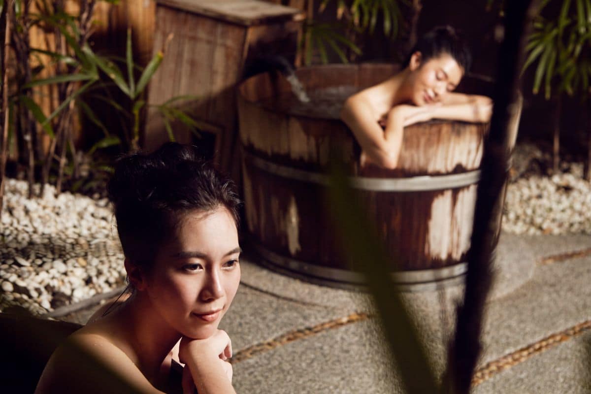A woman relaxing in a tub for her onsen experience in Bangkok 