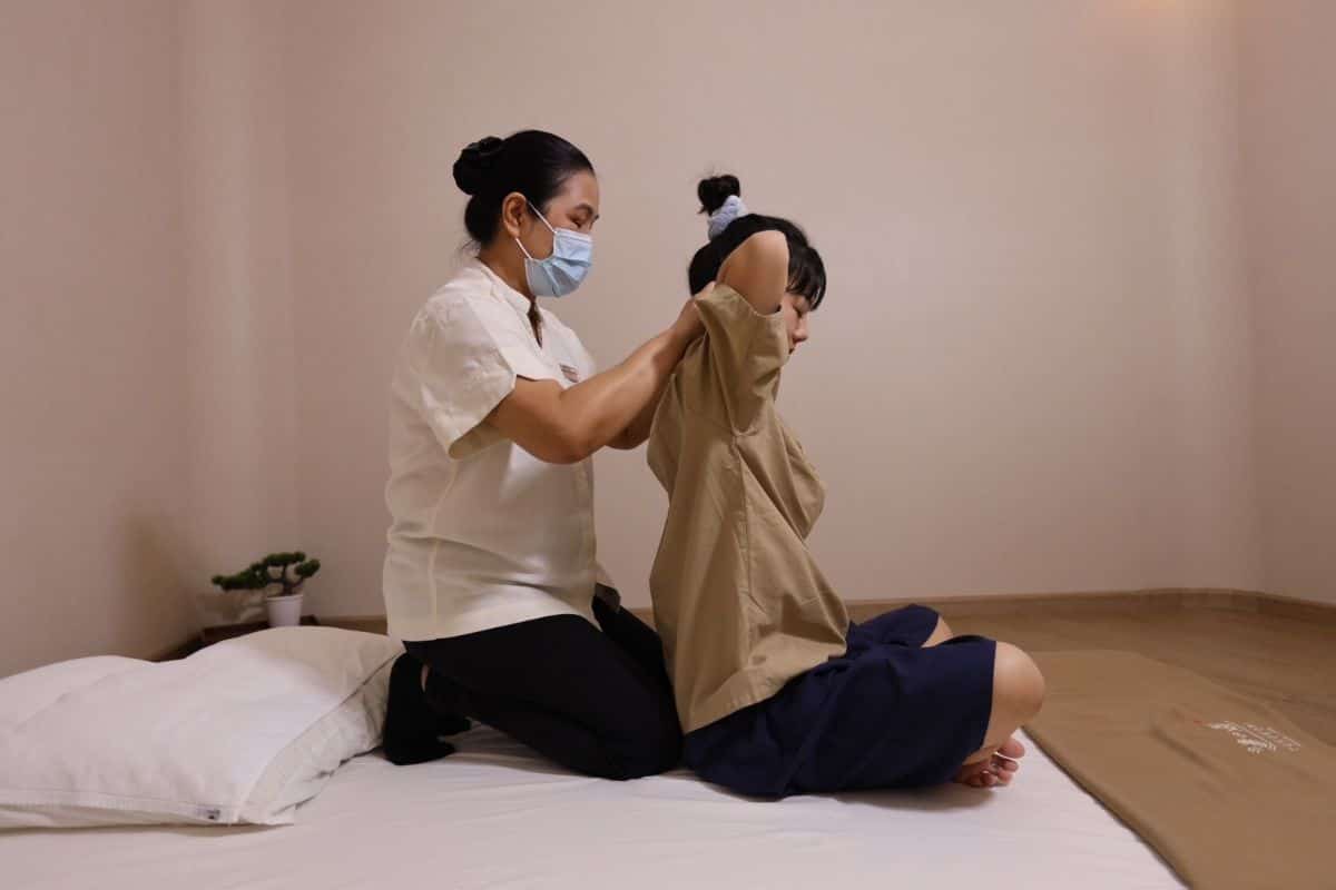 A young woman enjoying an authentic Thai massage in Bangkok