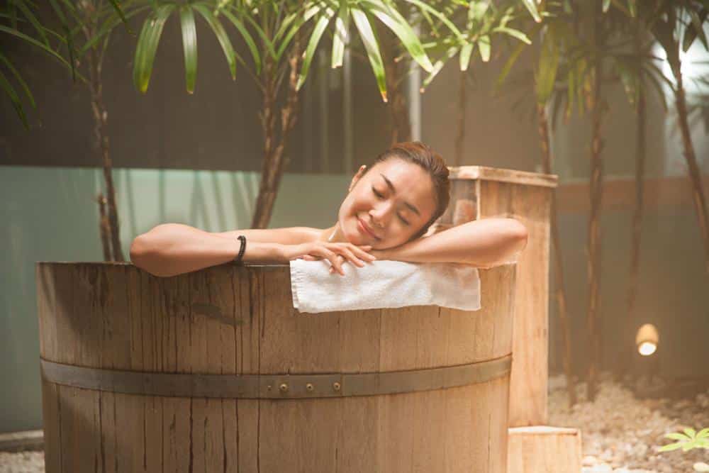 A woman indulging in Japanese onsen culture.