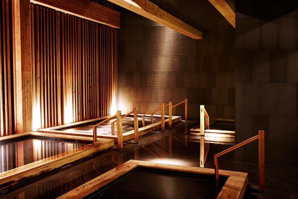 A woman preparing for an onsen bath after learning about the history of onsen in Japan.